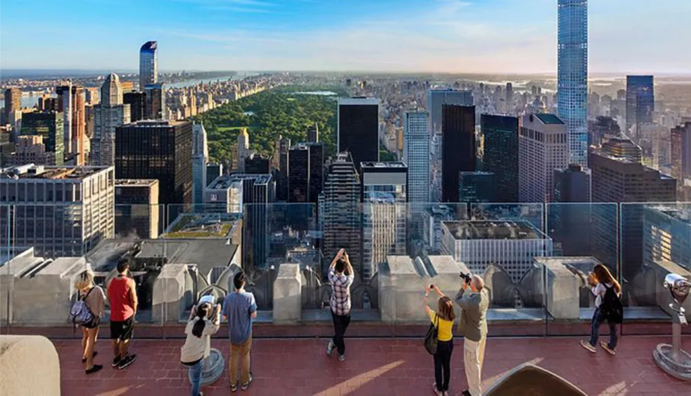 Visitors are enjoying the panoramic views of Central Park and the New York City skyline from an elevated observation deck