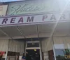 The image shows the entrance to Holstens an ice cream parlor with signage that includes words like Homemade Ice Cream and Home Made Chocolates suggesting an establishment that offers desserts and sweets