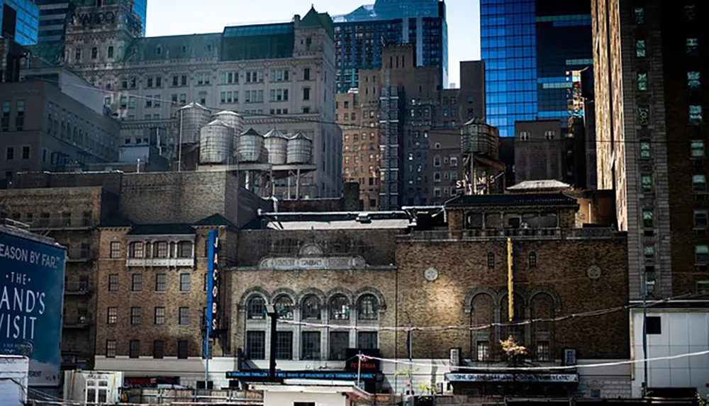 The image shows an eclectic mix of old and newer urban buildings with water towers atop which could be a bustling metropolis like New York City