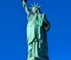 The image shows the Statue of Liberty against a clear blue sky