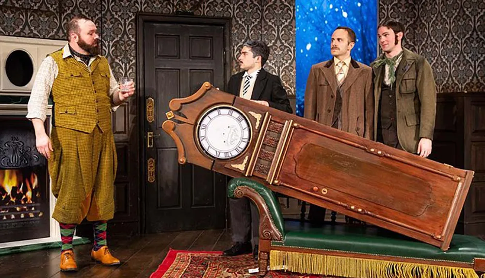 Four individuals in vintage attire stand around a large ornate wooden coffin with a built-in clock appearing to be in a room set for a theatrical play