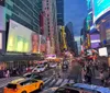 The image shows a vibrant and bustling Times Square at night illuminated by bright billboards and alive with the iconic yellow cabs of New York City