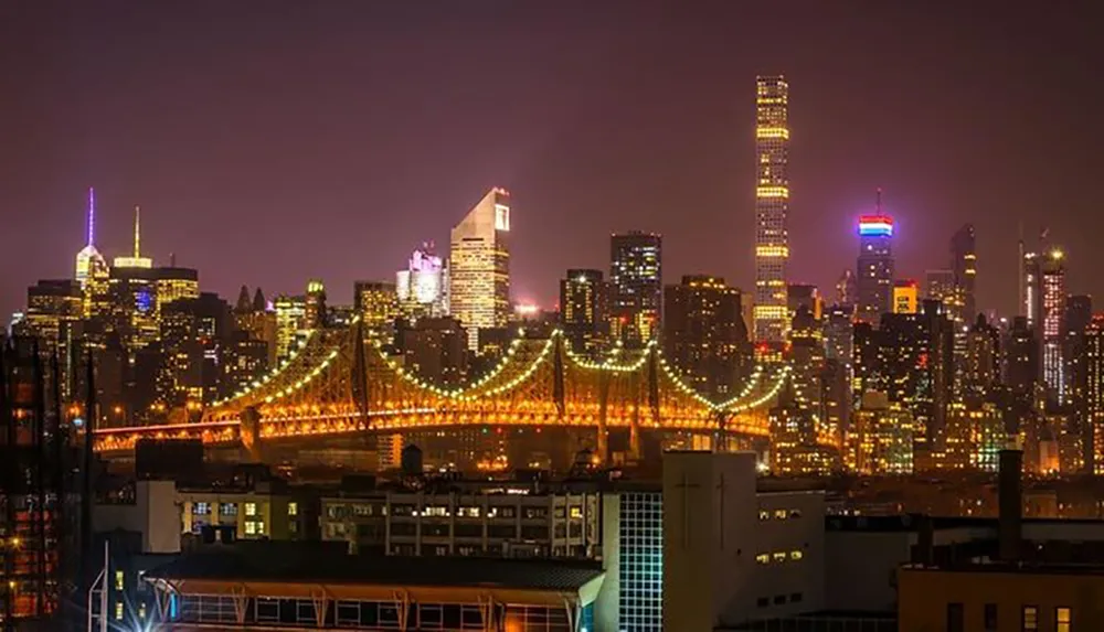 The image shows a stunning night view of a brightly lit suspension bridge in the foreground with a backdrop of a city skyline dotted with illuminated skyscrapers