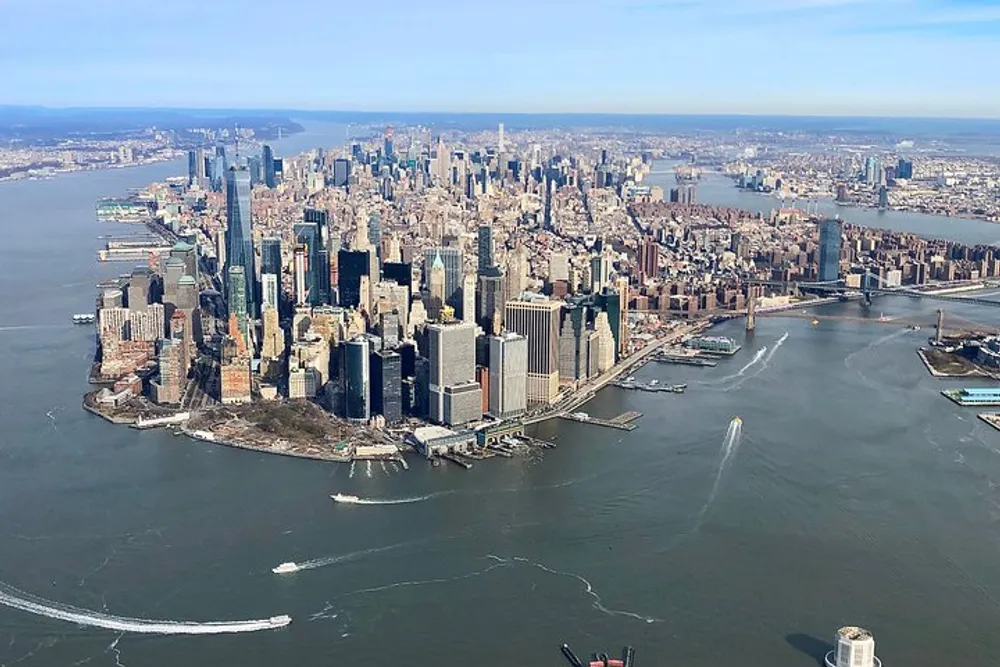 An aerial view of Manhattan New York City showcasing the dense skyline and surrounding waterways