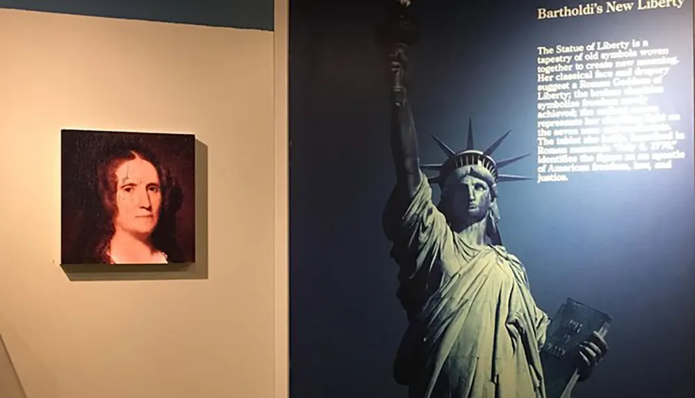 The image shows an exhibition space with a portrait of a person to the left a large image featuring the Statue of Liberty to the right and an informational text titled Bartholdis New Liberty in the background