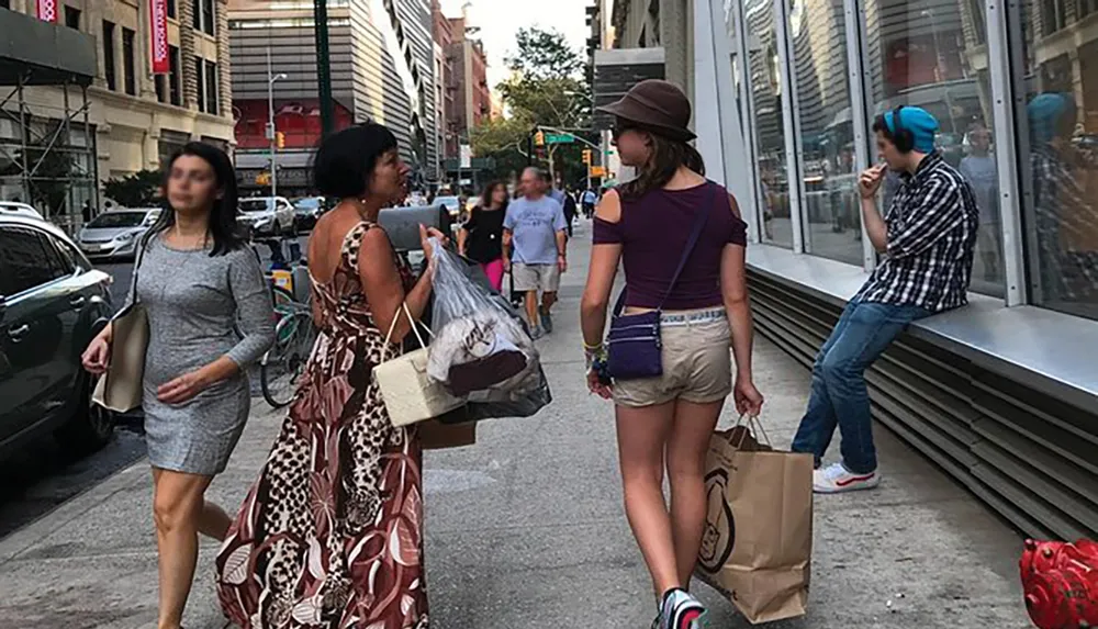 People are engaging in various activities on a bustling city sidewalk with some walking one person eating and another seemingly waiting illustrating the dynamism of urban life
