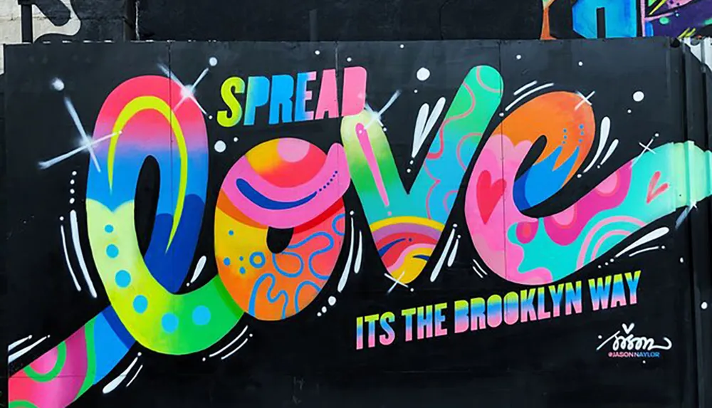 The image shows a colorful graffiti mural with the phrase SPREAD LOVE ITS THE BROOKLYN WAY painted on a wall