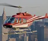 A red and white helicopter is flying over the city with skyscrapers in the background