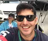 A group of smiling people is enjoying a ride in pedicabs on a sunny city street