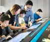 A family is interacting with a digital display at a modern educational exhibit