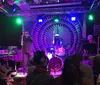 A jazz band performs on stage in an intimate venue with a cozy ambiance