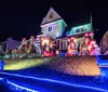 Visitors enjoy a festive display of Christmas decorations and illuminated figures at night