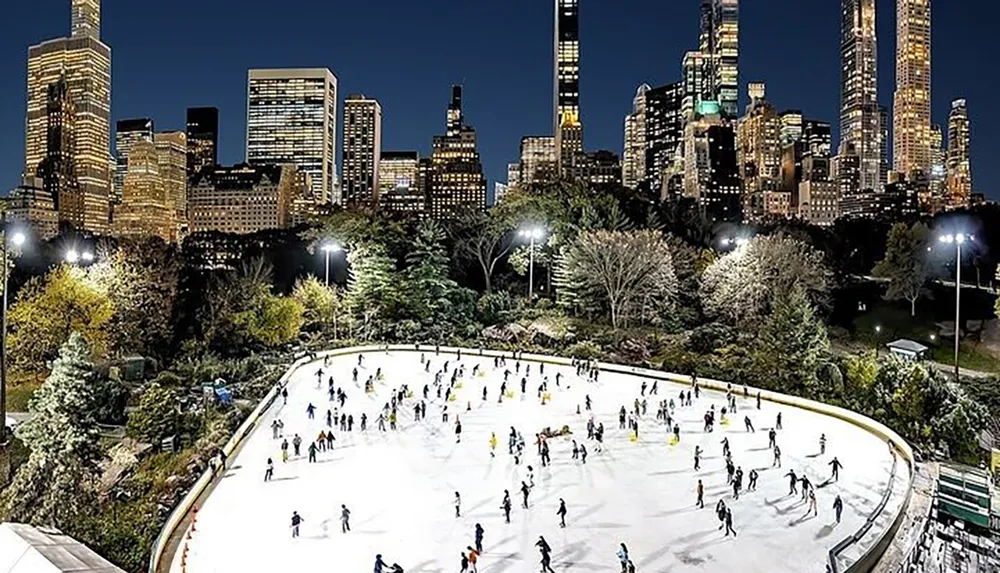 An ice skating rink teems with skaters in the evening set against a backdrop of the illuminated New York City skyline