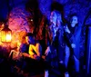 Three smiling people are looking at a glowing blue diamond-shaped object that one person is holding in their hand