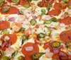 The image shows a close-up of a pizza topped with melted cheese pepperoni diced ham and sliced jalapeos