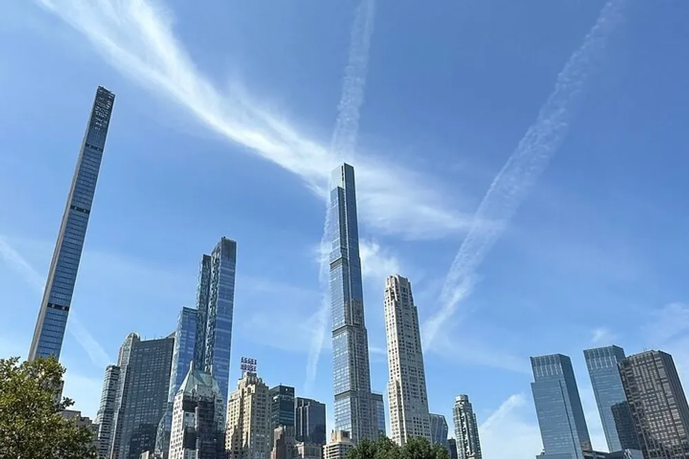 The image shows a modern cityscape with tall skyscrapers against a blue sky laced with contrails