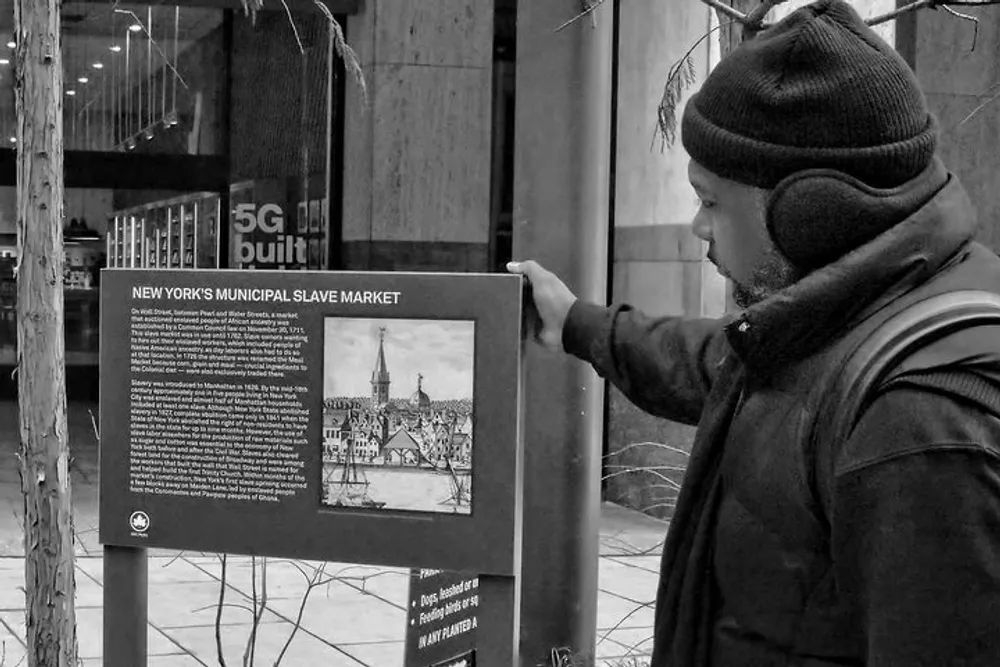 A person is reading an informational placard about New Yorks Municipal Slave Market