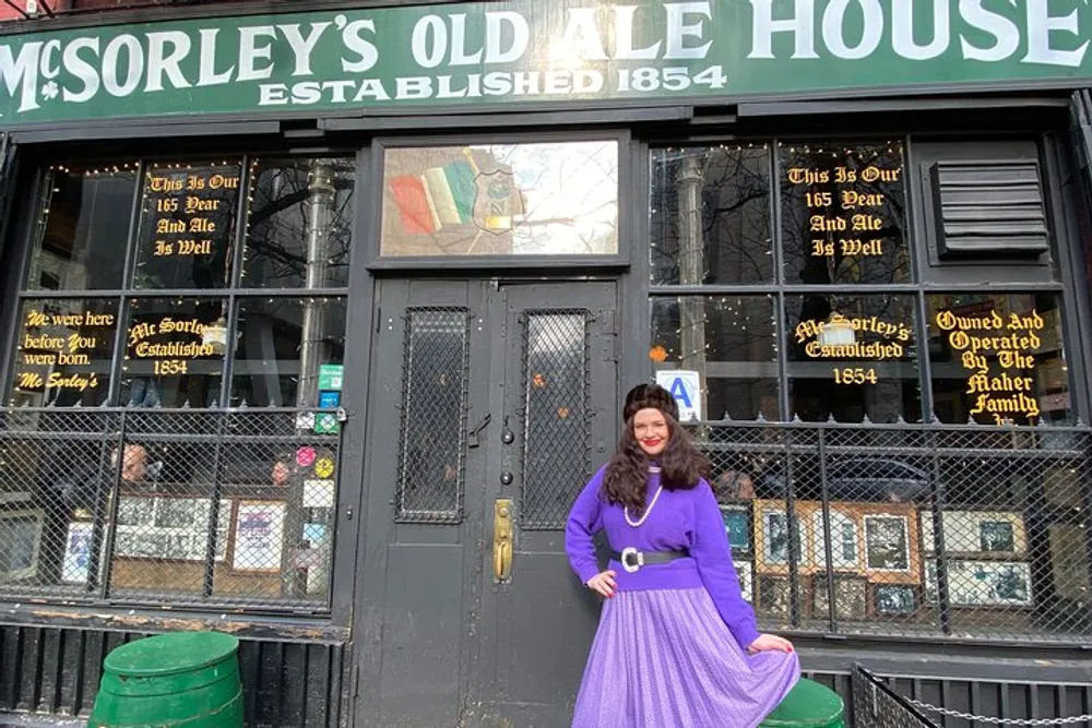 A person in a purple outfit is posing in front of McSorleys Old Ale House an establishment dating back to 1854