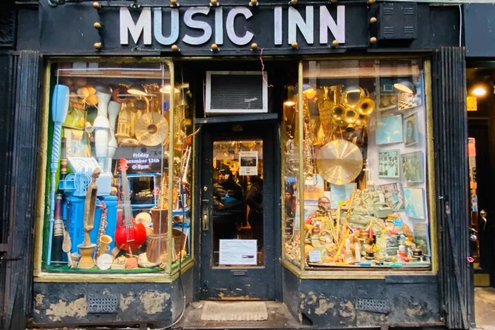 The image shows the storefront of Music Inn with its display windows filled with a variety of musical instruments and equipment