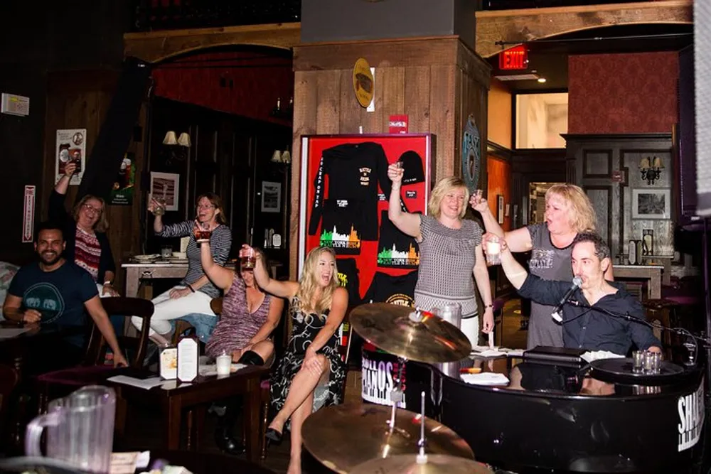 A lively group of people is celebrating and raising their glasses in a bar with live music