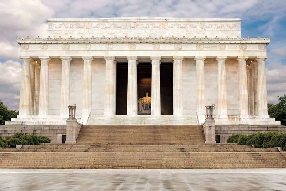 This image depicts the Lincoln Memorial a national monument in Washington DC with its towering white columns and the statue of Abraham Lincoln visible in the central chamber